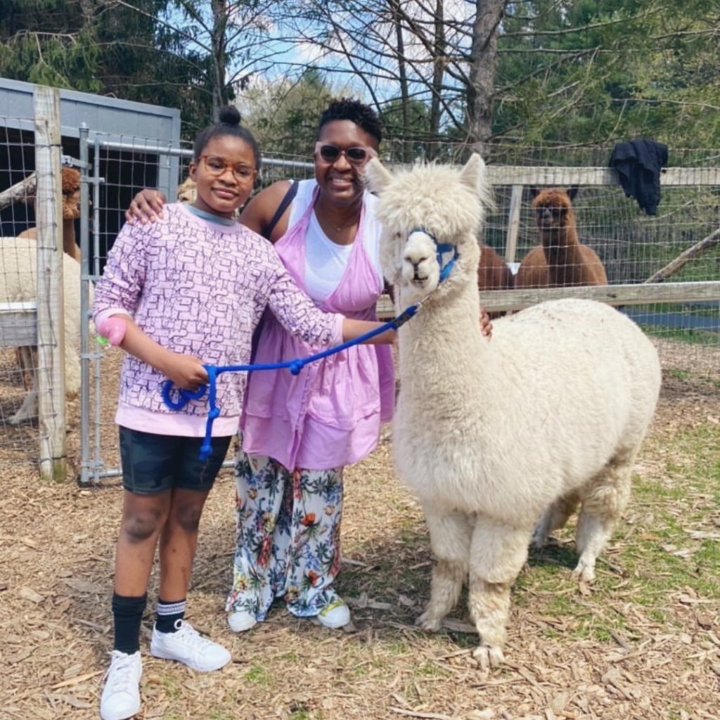 Family walking an alpaca